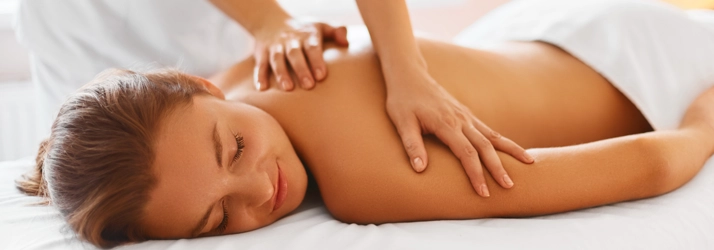 Chiropractic Brentwood CA Massage Therapy A woman peacefully laying face down on a massage table while receiving a massage